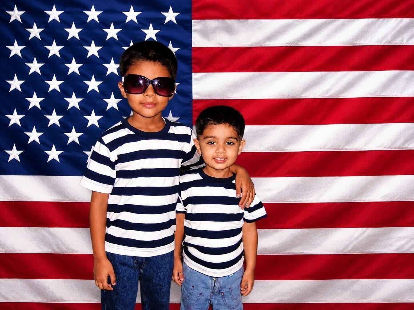 Two brothers holding an American flag.
