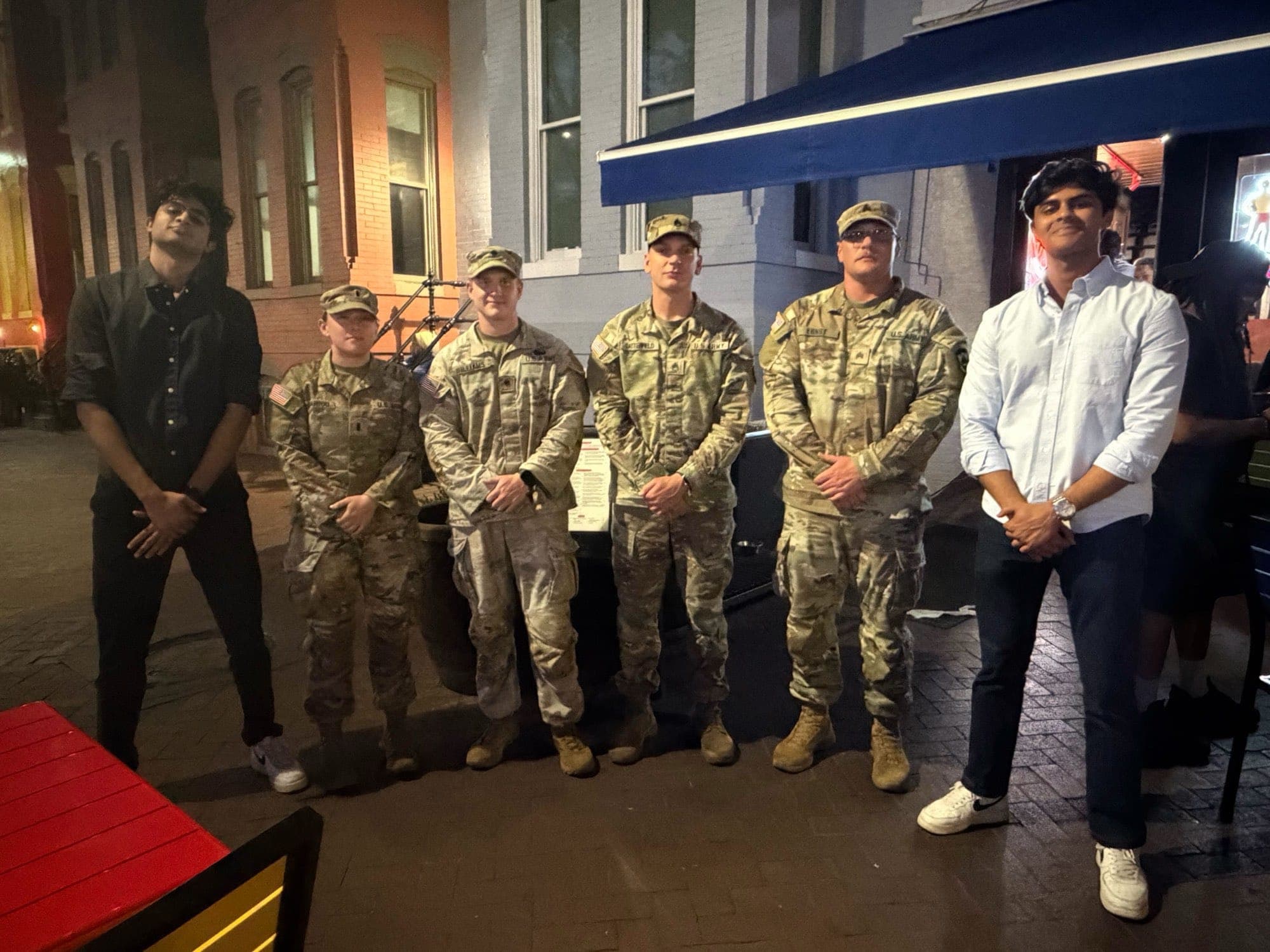 National Guard members standing together outdoors.